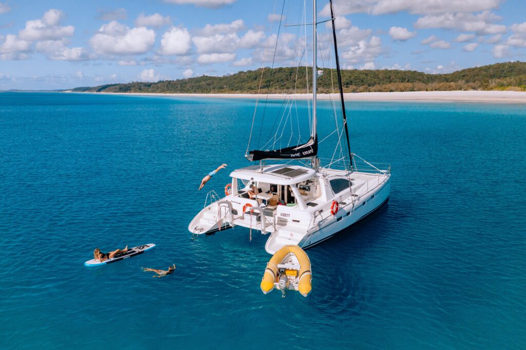 People swimming at the back of a Yacht